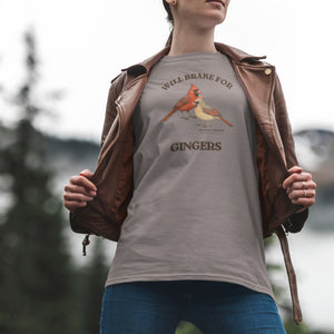 Person wearing a gray t-shirt with cardinal design and text, standing outdoors.