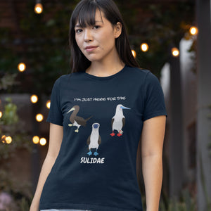 Navy women's fit birder shirt with a red-footed, blue-footed and brown booby on it, but referencing only the scientific family name for the bird. Worn by a woman.