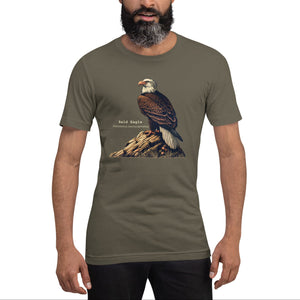 Army green unisex bird shirt with a Bald Eagle perched on a rock, next to its common and scientific names. Worn by a man.