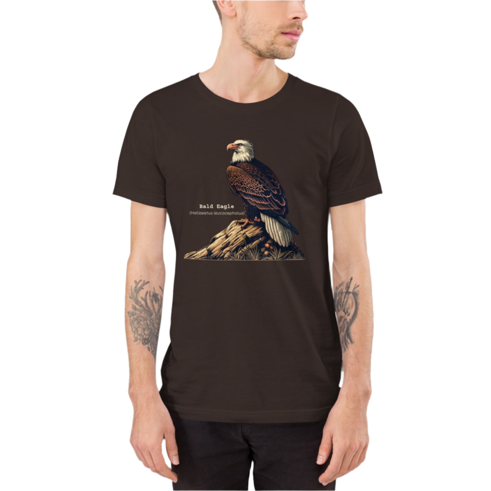 Brown unisex bird shirt with a Bald Eagle perches on a rock, next to its common and scientific names. Worn by a man.