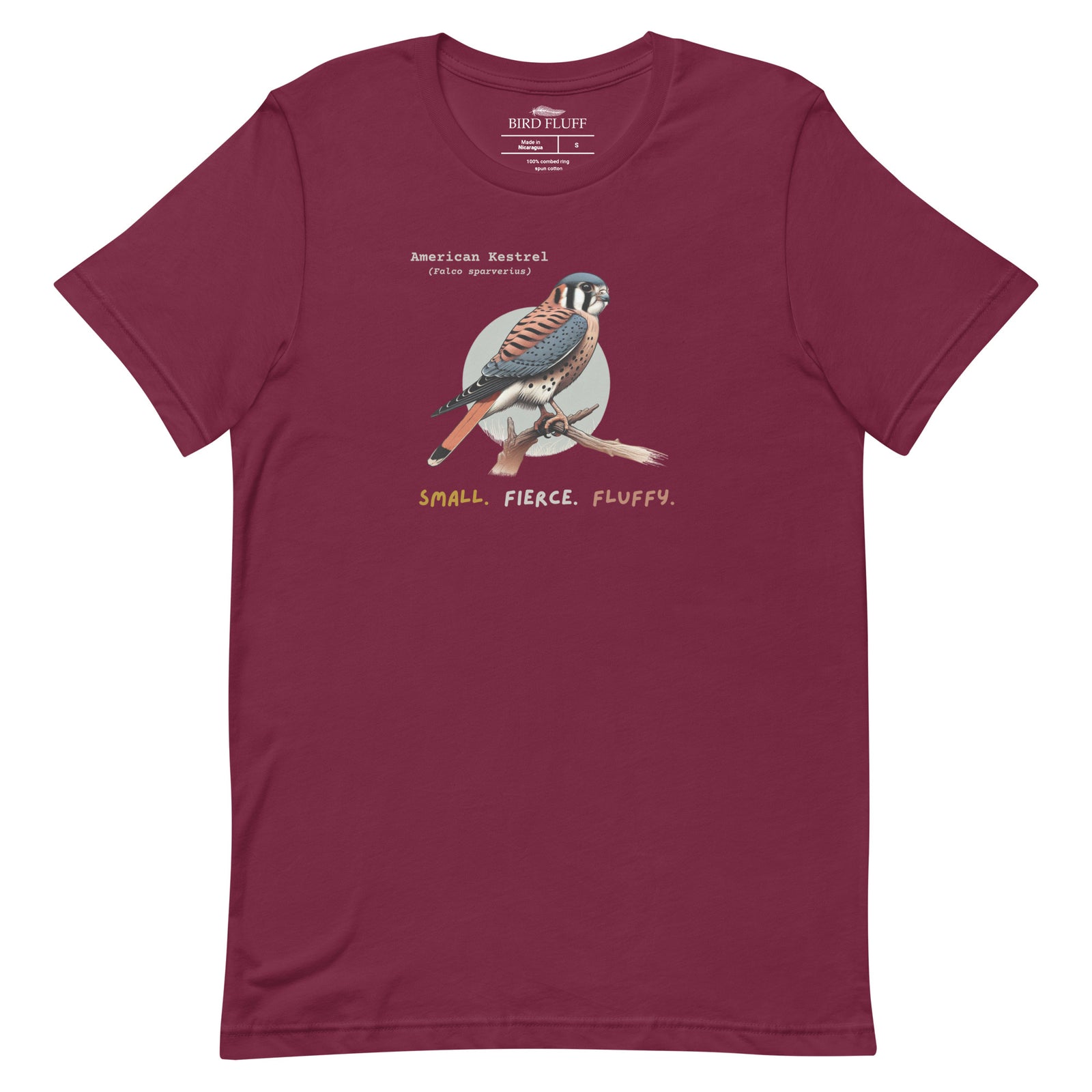 A maroon bird shirt with the words, "Small. Fierce. Fluffy" below an illustration of an American Kestrel.