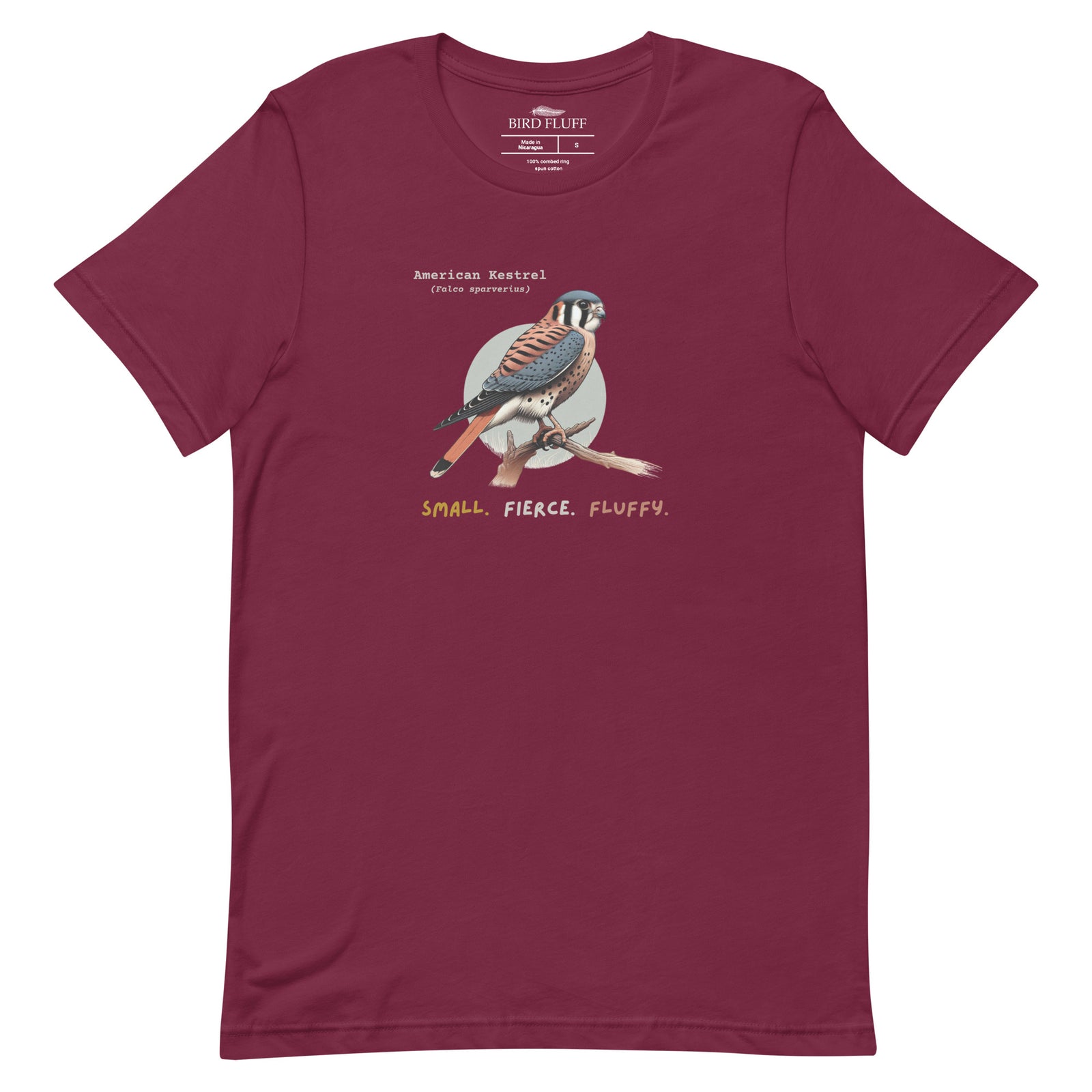 A maroon bird shirt with the words, "Small. Fierce. Fluffy" below an illustration of an American Kestrel.
