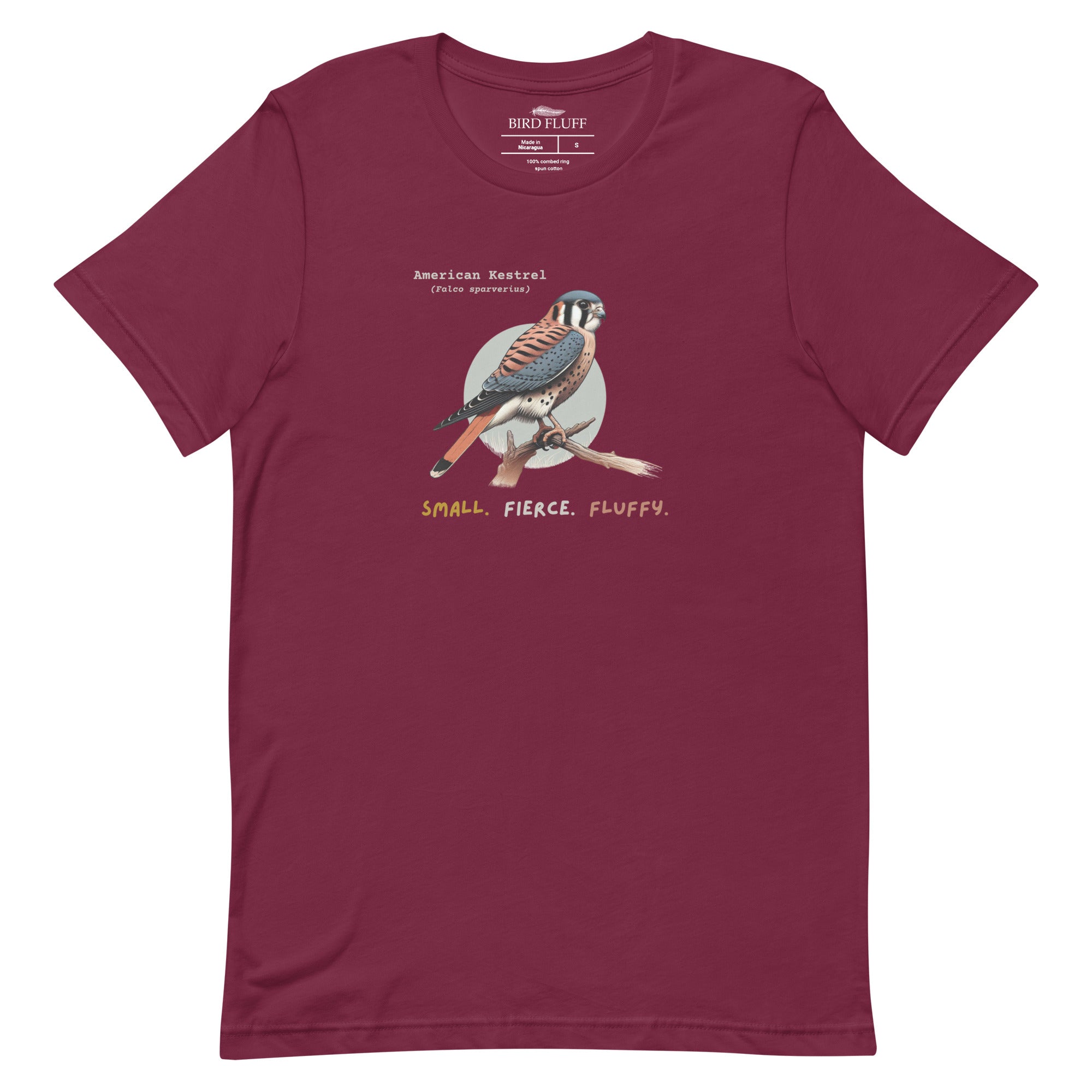 A maroon bird shirt with the words, "Small. Fierce. Fluffy" below an illustration of an American Kestrel.
