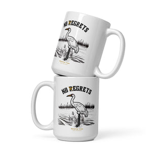 White 15-ounce mug featuring a play on the "No Regrets" tattoo that has the "R" crossed out to say "No Egrets" with a Whooping Crane below in a wetland setting.