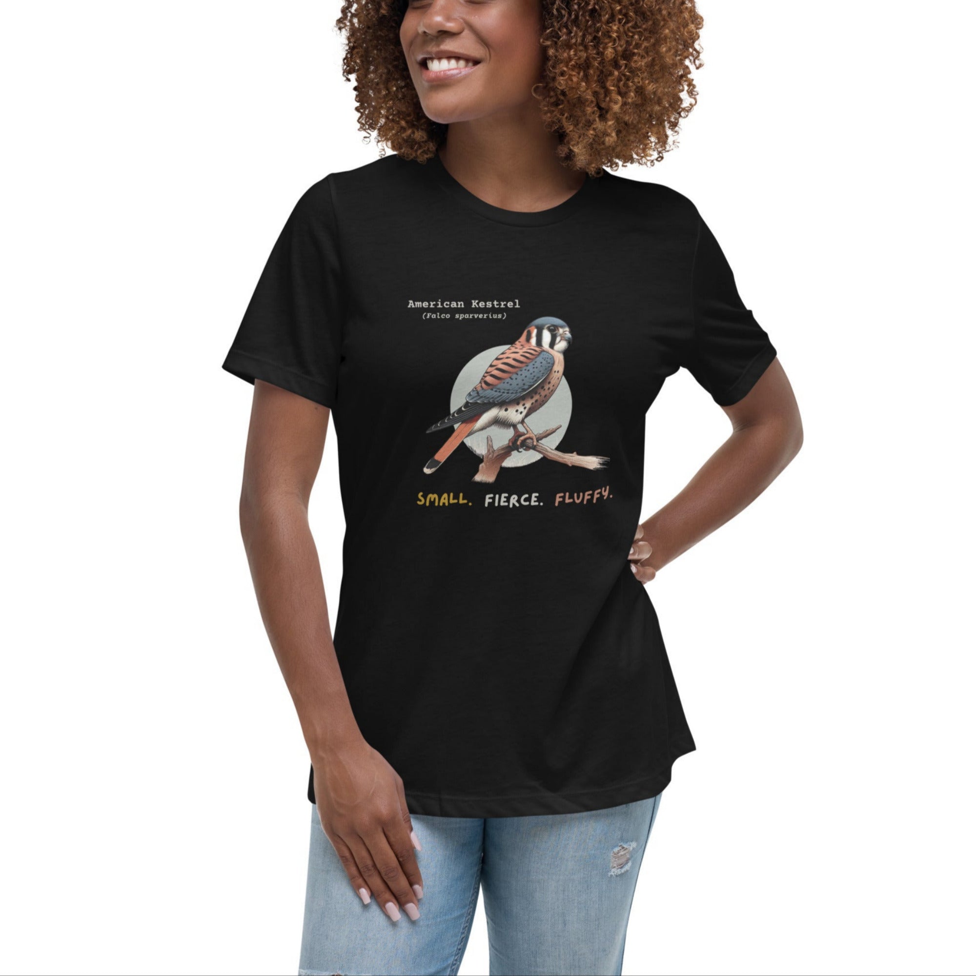 A black women's bird shirt with the words, "Small. Fierce. Fluffy" below an illustration of an American Kestrel. Worn by a woman.