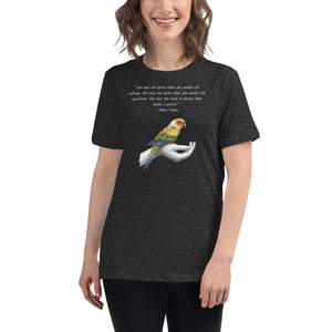Women's relaxed fit dark heather gray bird  t-shirt with a sun conure on a hand and a Mark Twain quote about a woman who keeps parrots. Worn by a woman.