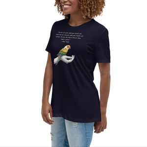 Women's relaxed fit navy blue bird  t-shirt with a sun conure on a hand and a Mark Twain quote about a woman who keeps parrots. Worn by a woman.