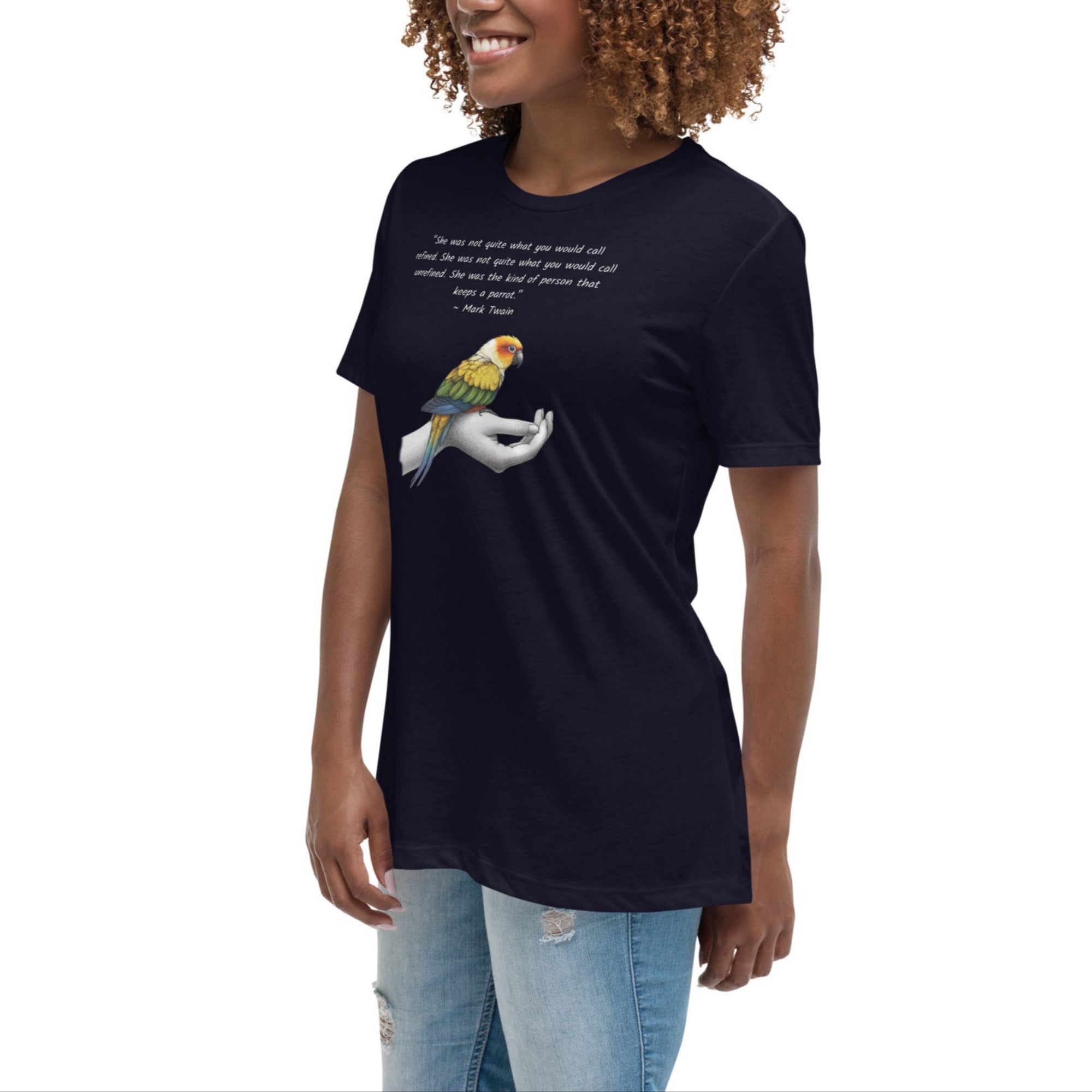 Women's relaxed fit navy blue bird  t-shirt with a sun conure on a hand and a Mark Twain quote about a woman who keeps parrots. Worn by a woman.