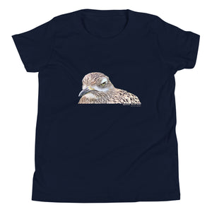 Navy unisex youth bird t-shirt with an illustrated picture of a spotted thick-knee bird looking grumpy. The words spotted thick-knee are written below the illustration, including the scientific name.