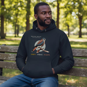 Navy hooded unisex bird sweatshirt with the words, "Small. Fierce. Fluffy" below an illustration of an American Kestrel.  Worn by a man.