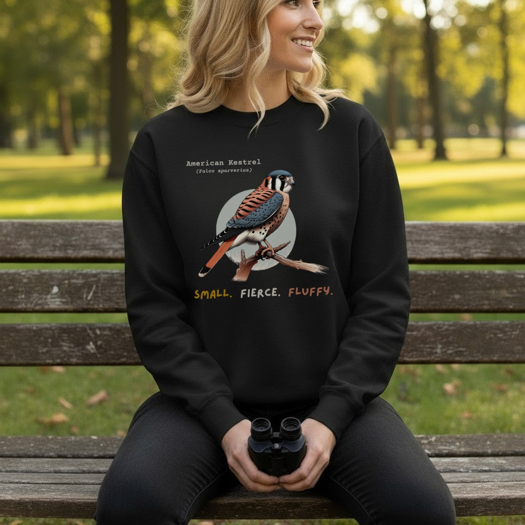 Black unisex bird sweatshirt with the words, "Small. Fierce. Fluffy" below an illustration of an American Kestrel. 