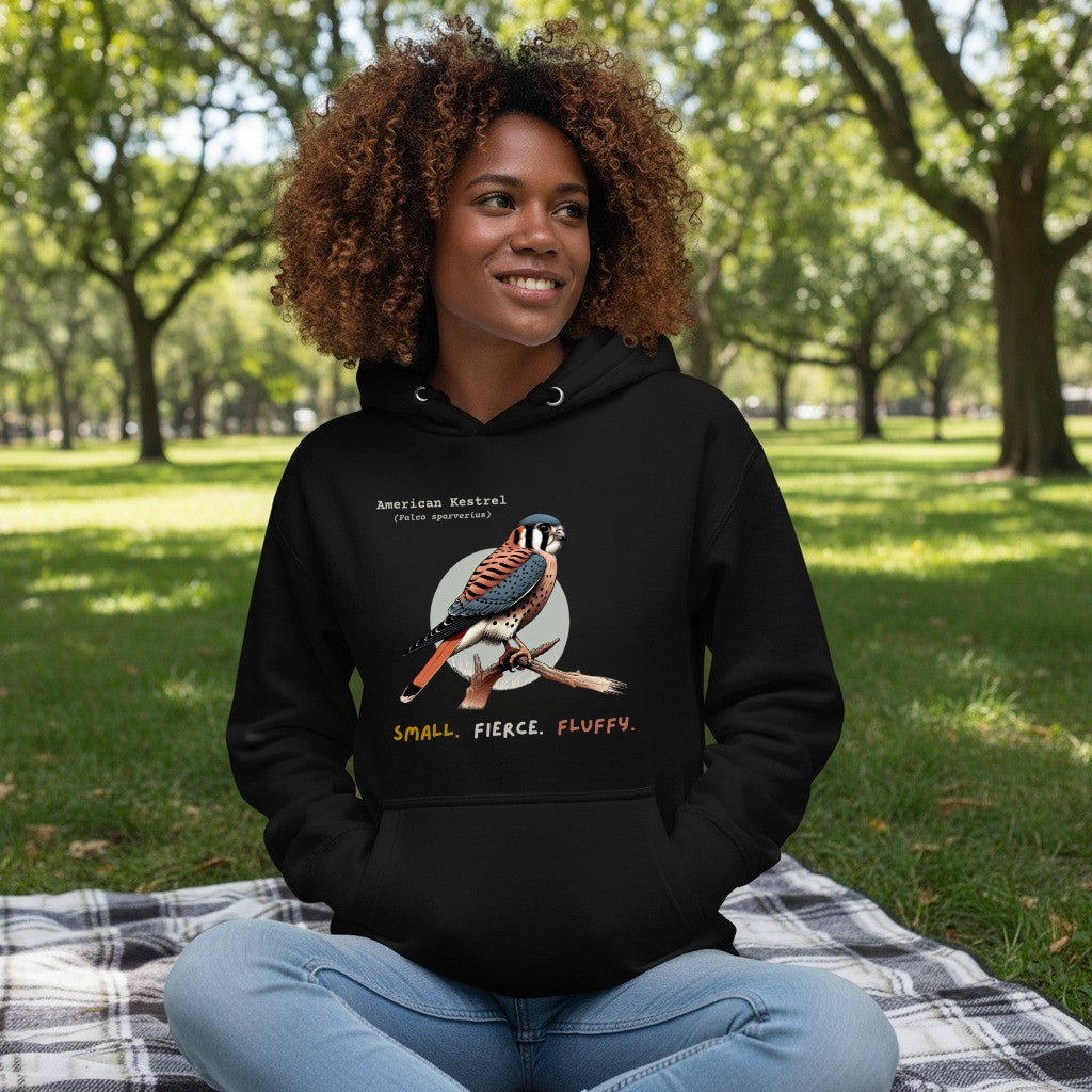 Black hooded unisex bird sweatshirt with the words, "Small. Fierce. Fluffy" below an illustration of an American Kestrel. 