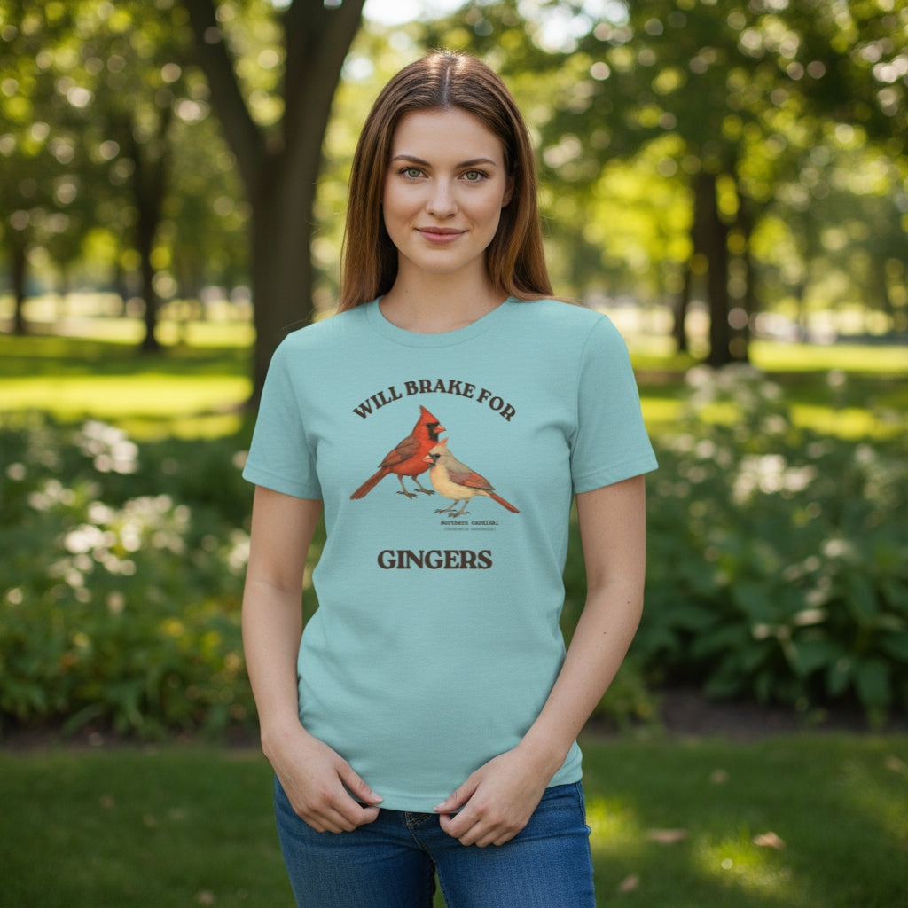 Heather light blue women's relaxed fit bird shirt with a male and female northern cardinal and the words, "Will Brake for Gingers" worn by a woman in a park.