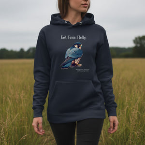 Navy, long-sleeve, bird hoodie with a peregrine falcon under the words, Fast, Fierce, Fluffy. Worn by a woman walking in a field.