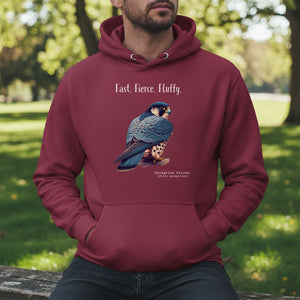 Maroon, long-sleeve, bird hoodie with a peregrine falcon under the words, Fast, Fierce, Fluffy. Worn by a man sitting in a park.