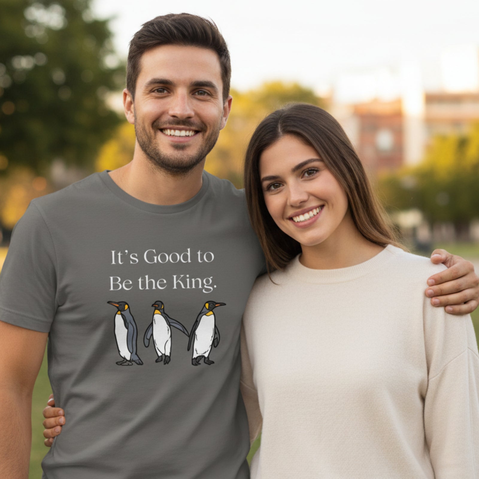 Gray unisex t-shirt with the words, "It's Good To Be the King." on the front and graphics of King Penguins below.