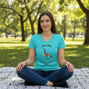 Turquoise women's relaxed v-neck bird t-shirt with a canada goose on the front and a park department theme. Worn by a woman.