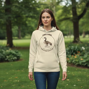 Unisex off white bird hoodie with a canada goose on the front and a park department theme. Worn by a woman in a park.