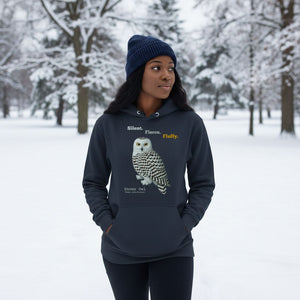 Person wearing a navy hoodie with a snowy owl design in a snowy landscape