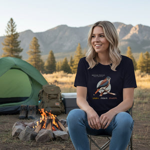 A navy blue women's bird shirt with the words, "Small. Fierce. Fluffy" below an illustration of an American Kestrel. Worn by a woman at a campsite.