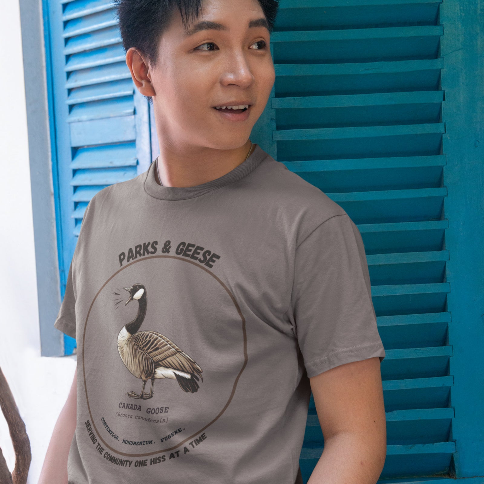 Unisex light tan bird shirt with a canada goose on the front and a park department theme. 