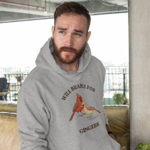 Man wearing a gray hoodie with a cardinal design and text indoors.