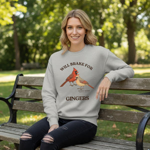 Gray sweatshirt with male and female cardinal design and text 'WILL BRAKE FOR GINGERS' Worn by a woman.