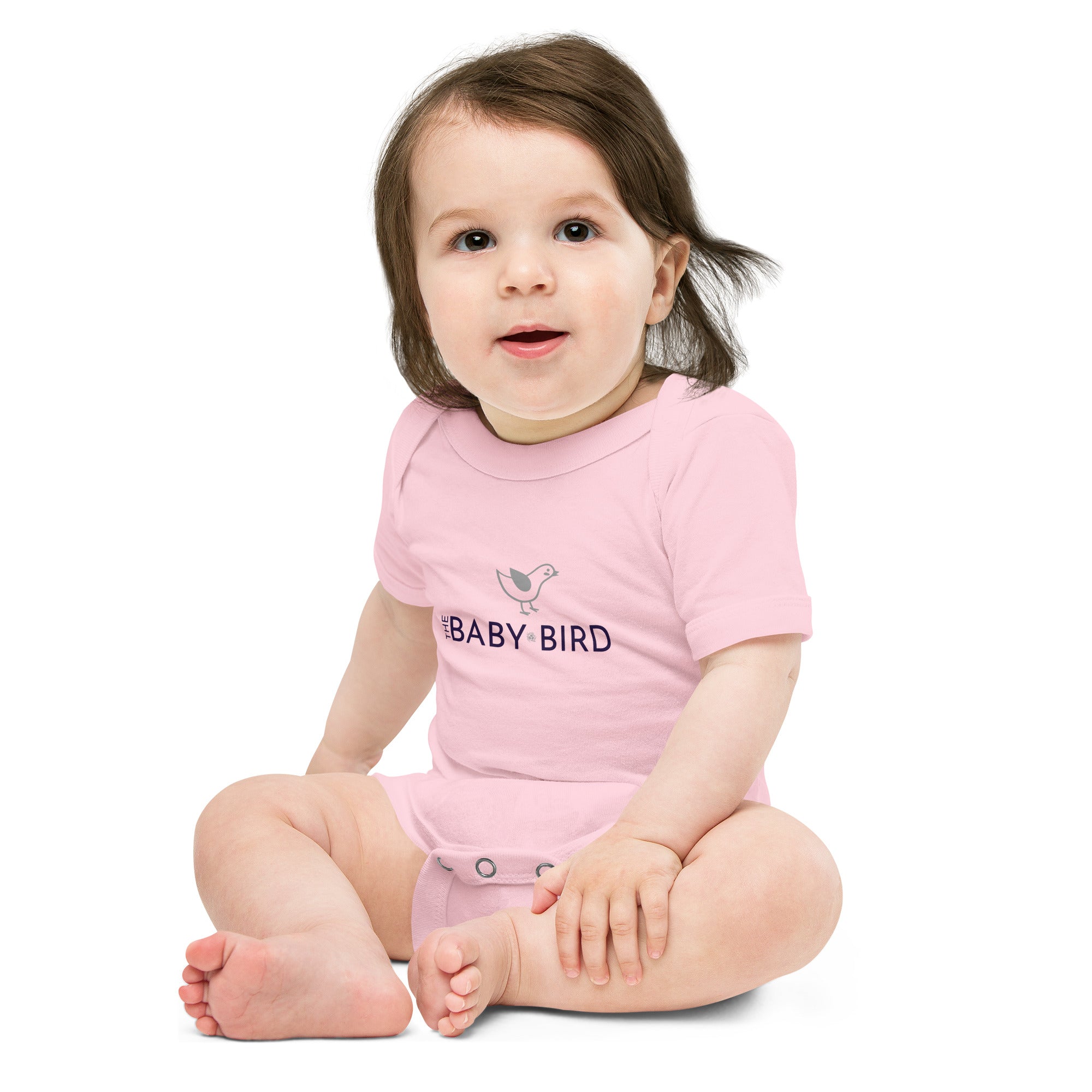 Light pink baby bodysuit with a graphic of a bird and the words The Baby Bird beneath.