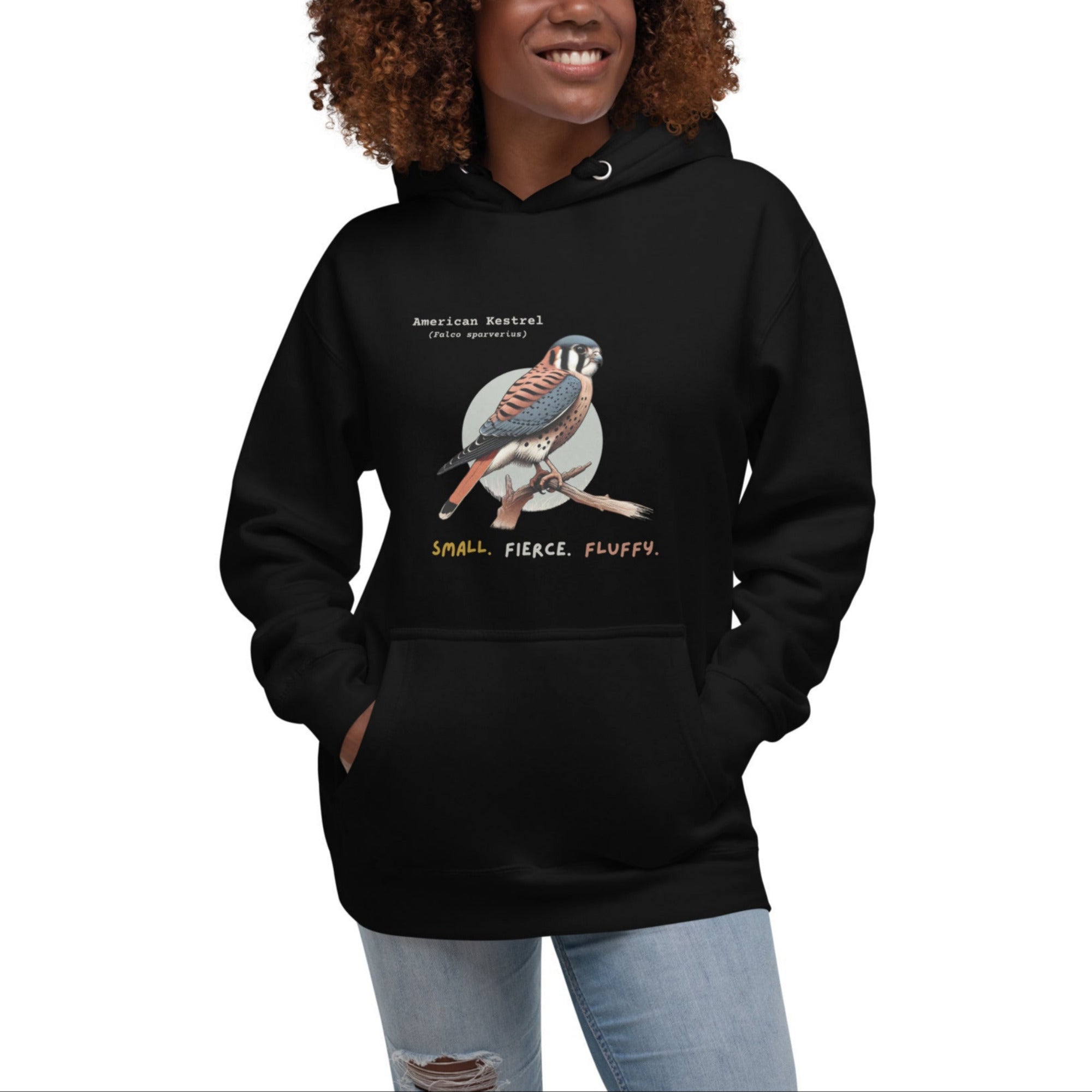 Black hooded unisex bird sweatshirt with the words, "Small. Fierce. Fluffy" below an illustration of an American Kestrel. 