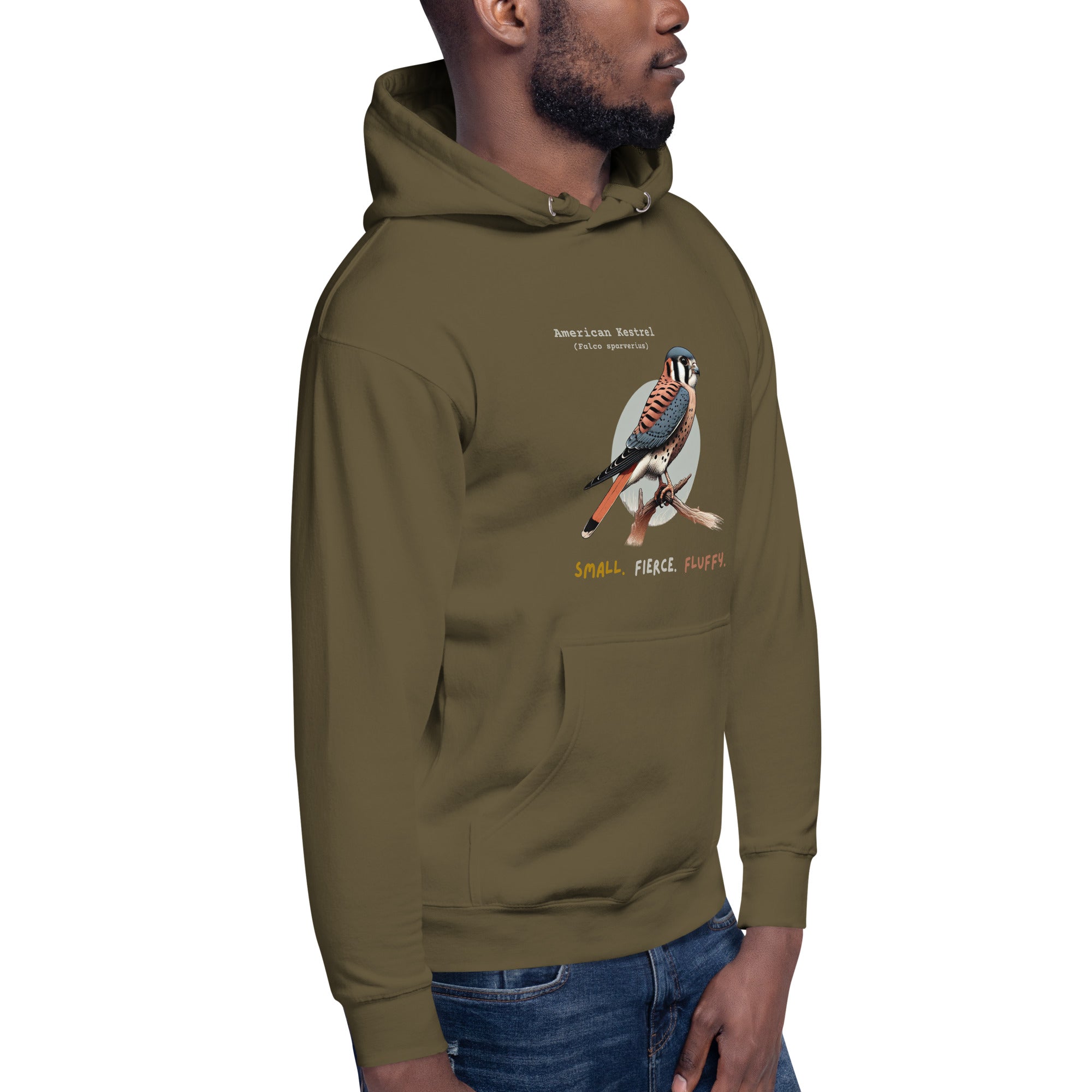 Military green hooded unisex bird sweatshirt with the words, "Small. Fierce. Fluffy" below an illustration of an American Kestrel. Worn by a man.