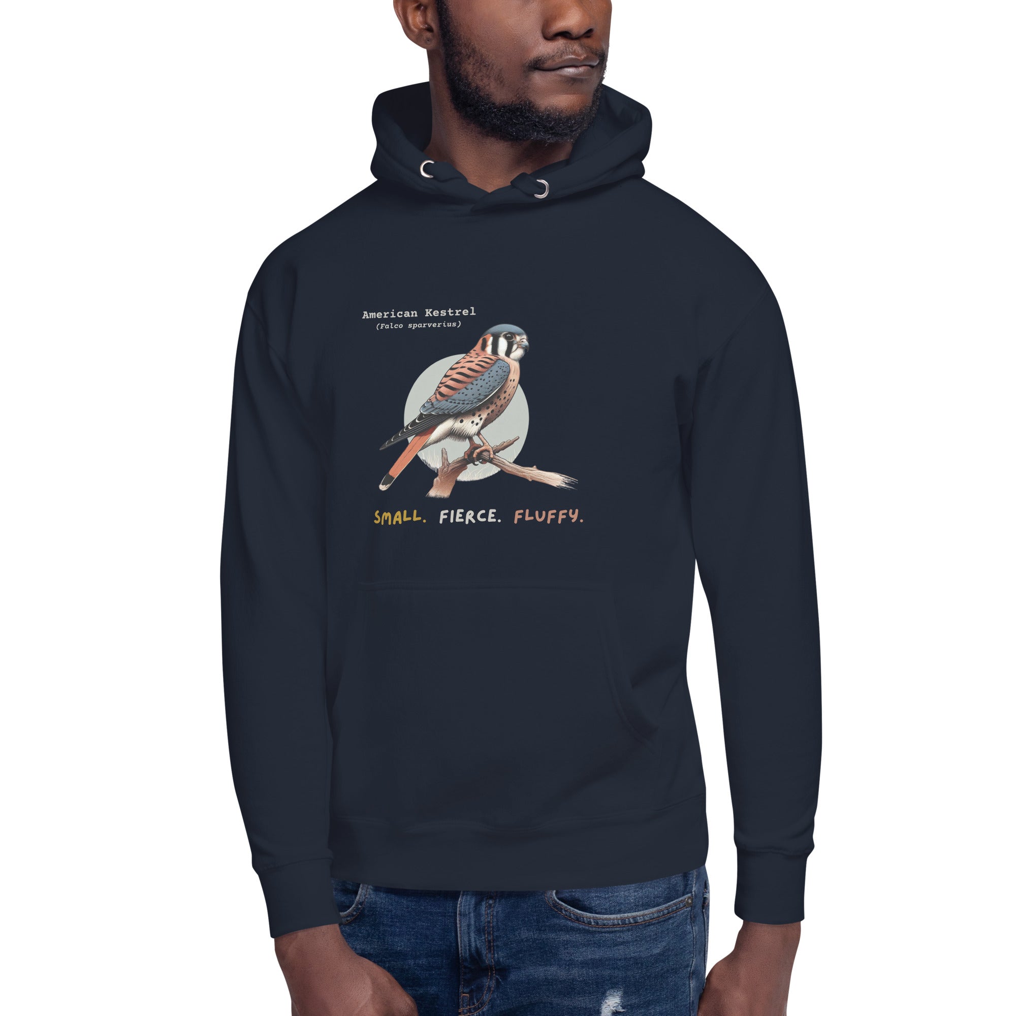 Navy hooded unisex bird sweatshirt with the words, "Small. Fierce. Fluffy" below an illustration of an American Kestrel.  Worn by a man.