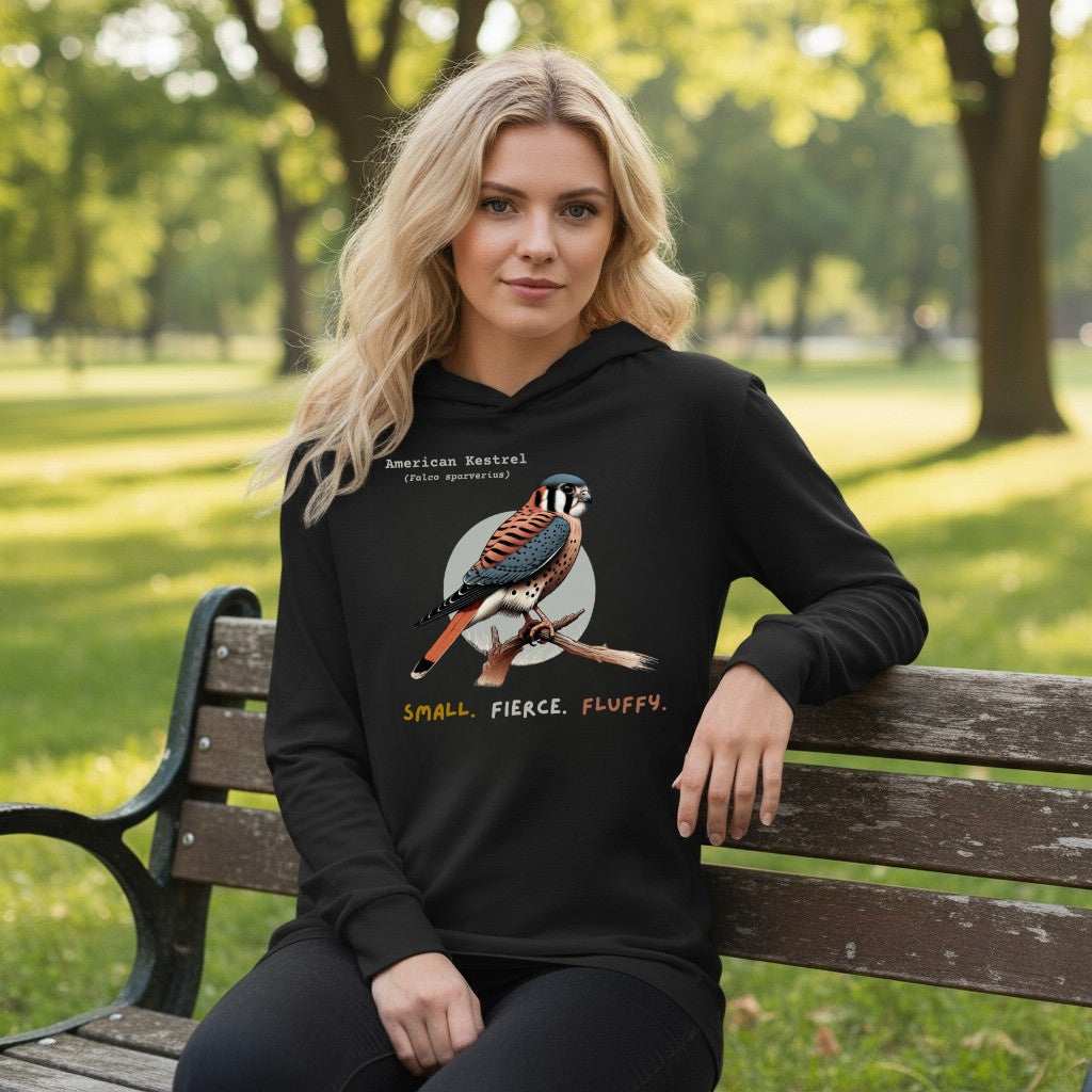 Black long sleeved and hooded unisex bird shirt with the words, "Small. Fierce. Fluffy" below an illustration of an American Kestrel. 
