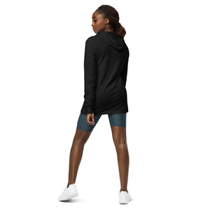 Black long sleeved and hooded unisex bird shirt with the words, "Small. Fierce. Fluffy" below an illustration of an American Kestrel. Worn by a woman, rear view, no graphics shown.
