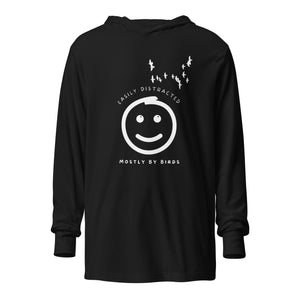 Black long sleeved and hooded tee with fun, "Easily Distracted, Mostly by Birds" saying on the front, with a smiley face looking up at a flock of birds.