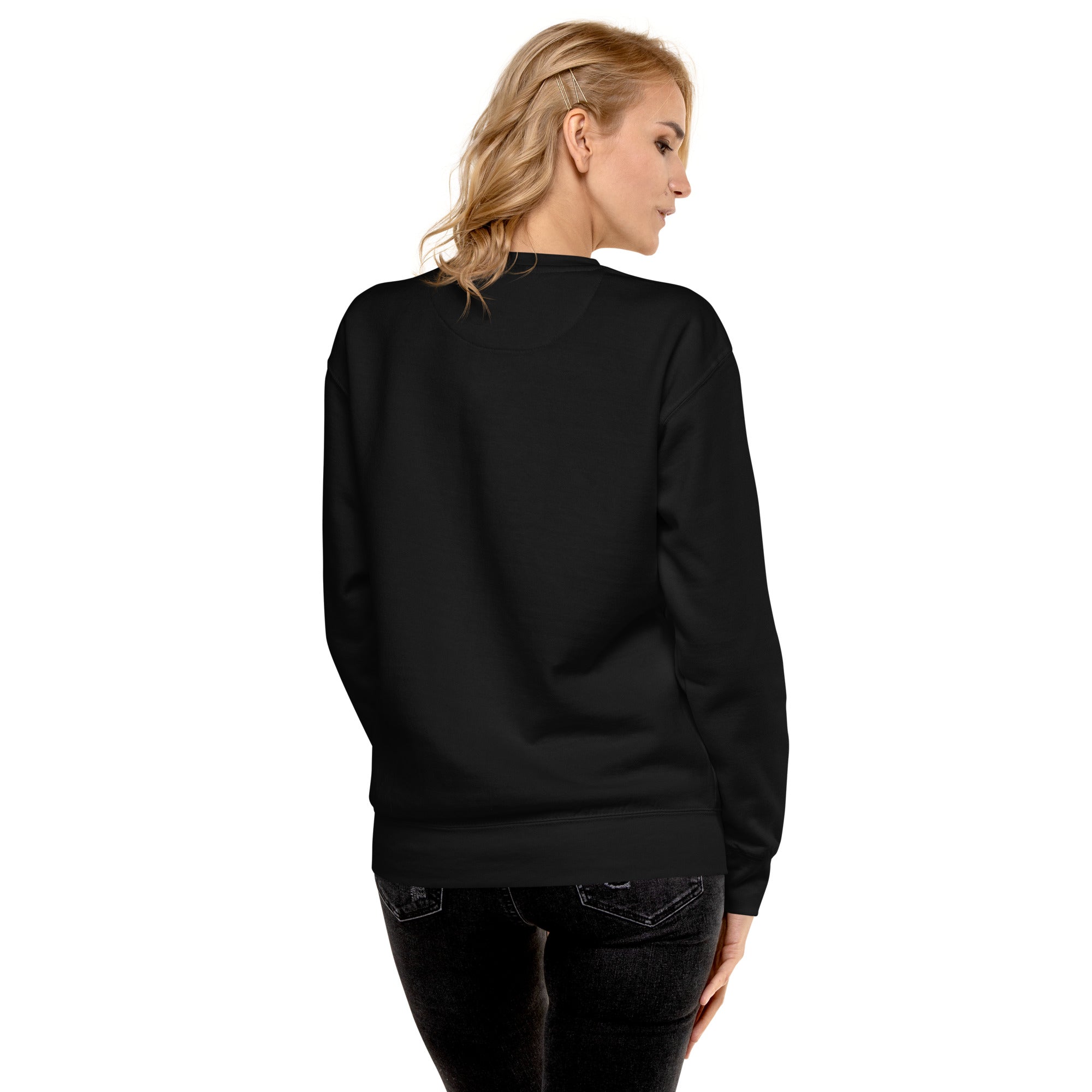 Black unisex bird sweatshirt with the words, "Small. Fierce. Fluffy" below an illustration of an American Kestrel. Worn by a woman. Rear view, no graphics shown.