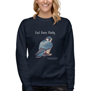Navy crewneck bird sweatshirt with a peregrine falcon under the words, Fast, Fierce, Fluffy. Worn by a woman on a white background.