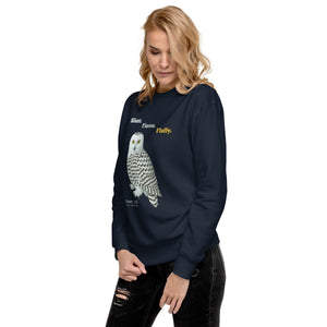 Woman wearing a navy sweatshirt with a snowy owl design and text on a white background