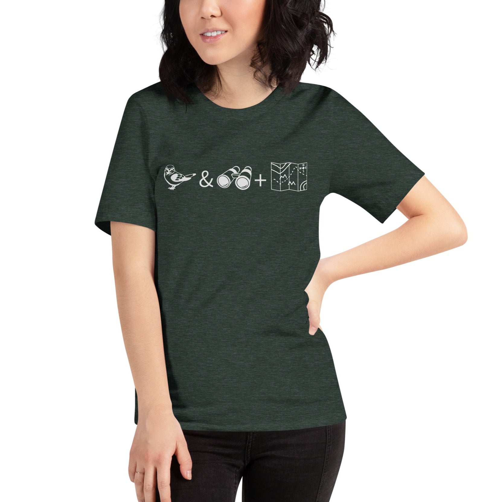 Unisex forest green heather bird t-shirt celebrating bird watching and the backcountry with a graphic of binoculars, a bird, and a map. Worn by a woman.