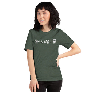 Forest green heather bird shirt with a bird, binoculars and cup of coffee. Worn by a woman.