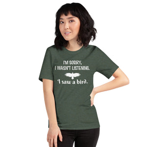 Heather forest green bird t-shirt with the words I'm sorry I wasn't listening, I saw a bird. And a graphic of a bird flying. Worn by a female model.