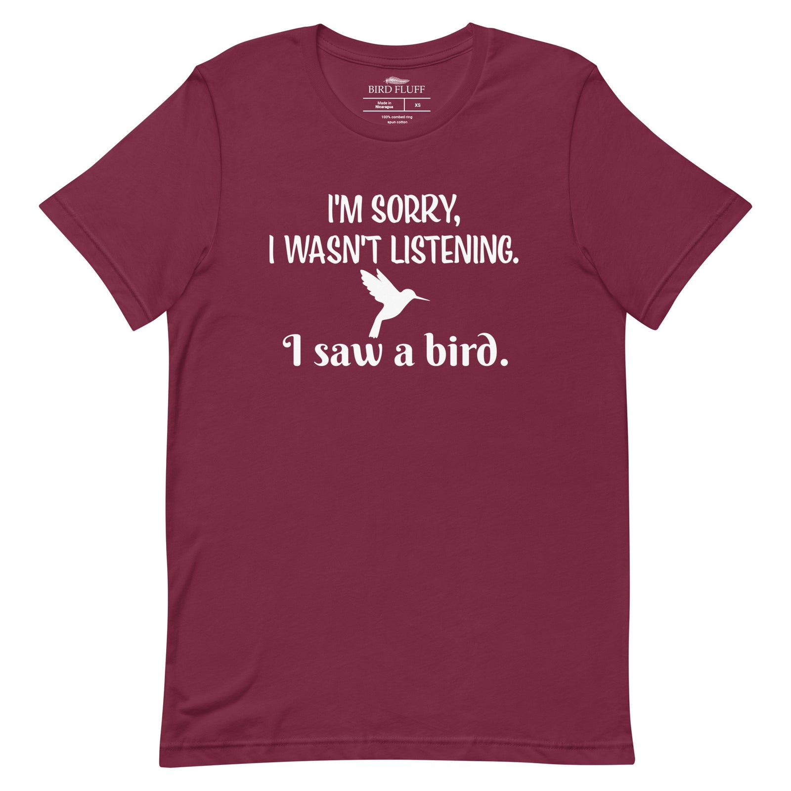Maroon bird t-shirt with the words I'm sorry I wasn't listening, I saw a bird. And a graphic of a hummingbird flying. 