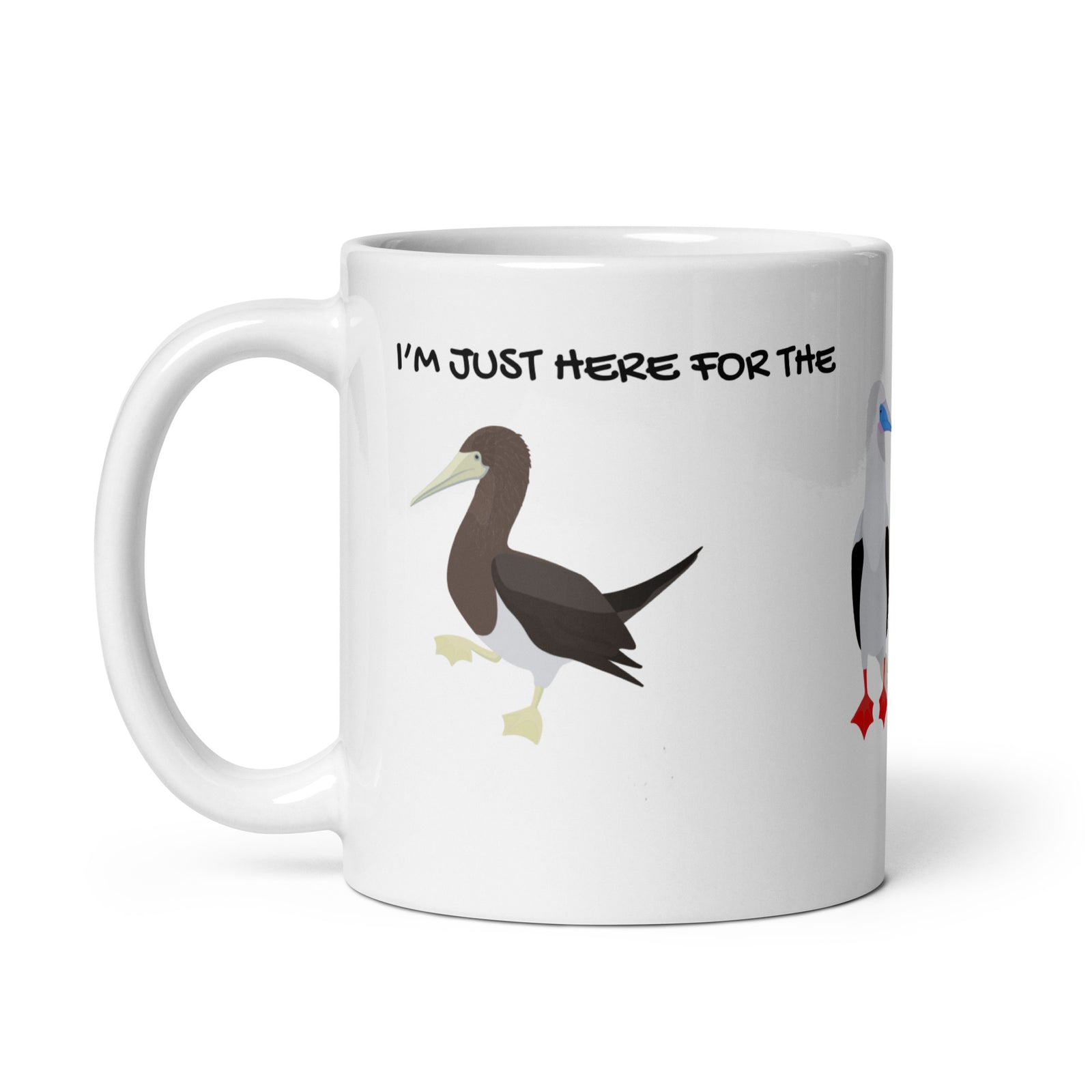 white glossy 11 ounce mug with illustrations of the blue-footed, red-footed and brown booby and the words, "I'm just here for the Sulidae." Mug handle to the right.