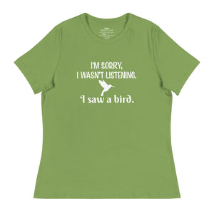 Leaf green women's relaxed crew neck bird t-shirt with the words I'm sorry I wasn't listening, I saw a bird. And a graphic of a hummingbird flying.