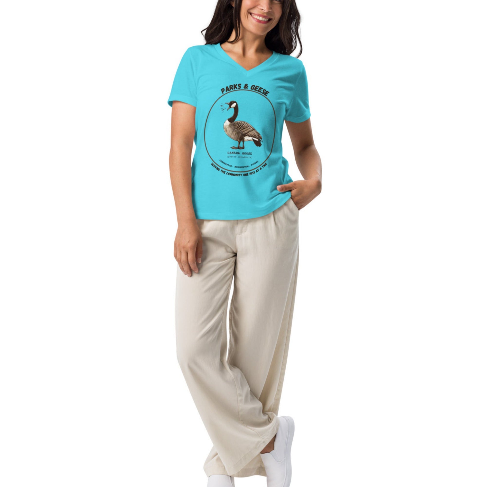 Turquoise women's relaxed v-neck bird t-shirt with a canada goose on the front and a park department theme. Worn by a woman.