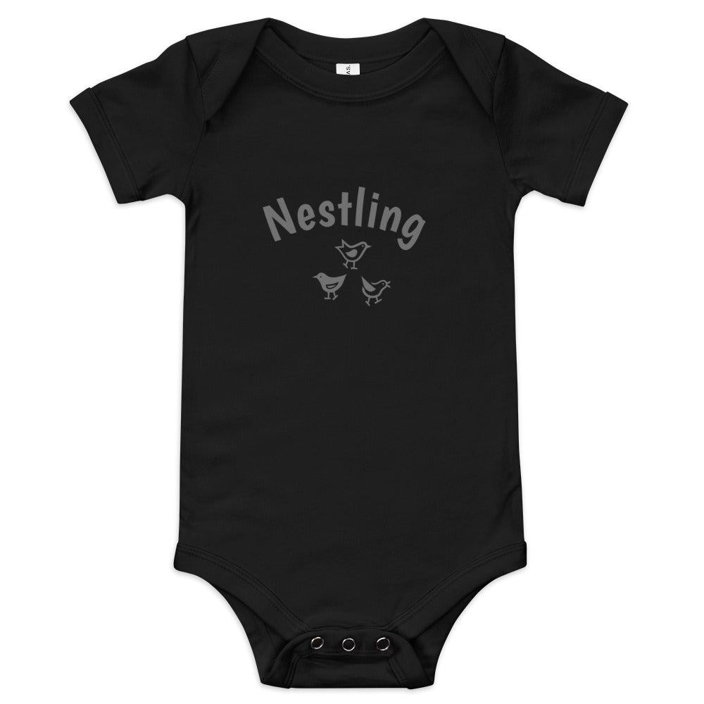 Black one-piece baby suit with the word Nestling on the front above three small birds in grey.